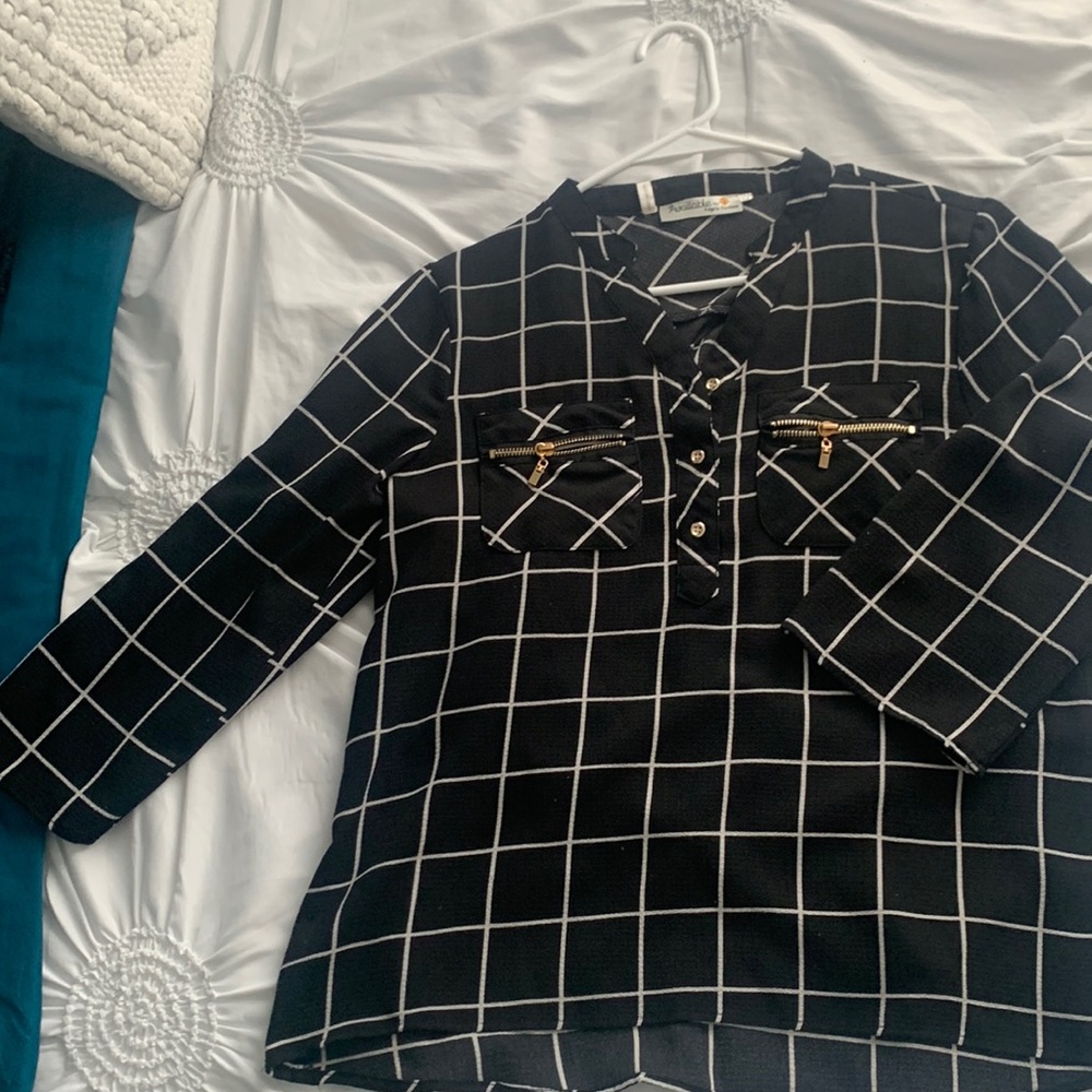 Black and white polyester blouse.